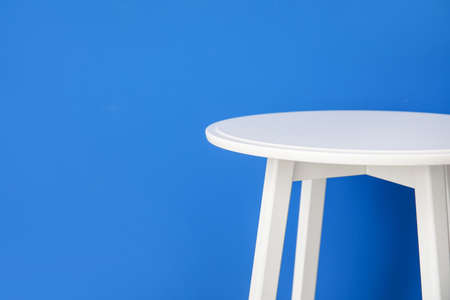 Stylish table near color wall