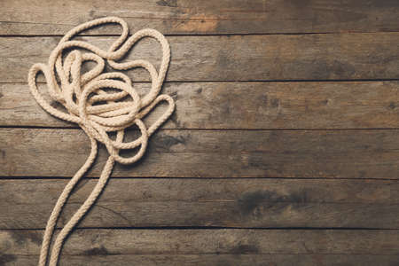 Long rope on wooden background