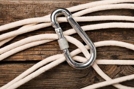 Rope with lobster clasp on wooden background, closeupの写真素材