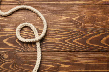 Long rope on wooden background