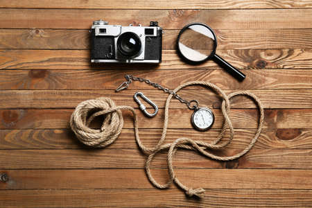 Set of travel items with rope on wooden backgroundの写真素材