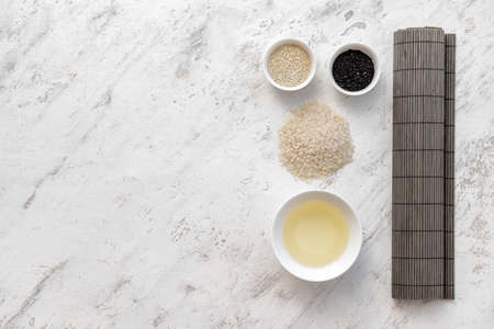 Composition with ingredients for preparing sushi rolls and rice vinegar on light backgroundの写真素材