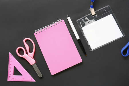 Blank badge and stationery on dark background