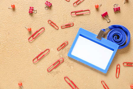 Blank badge and stationery on color background