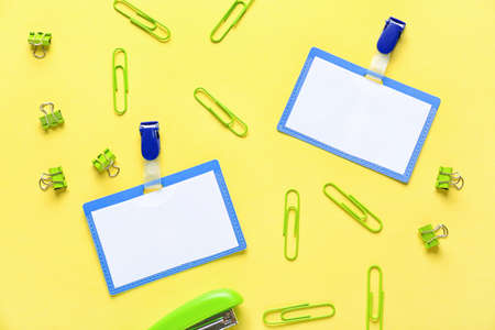 Blank badges and stationery on color backgroundの写真素材