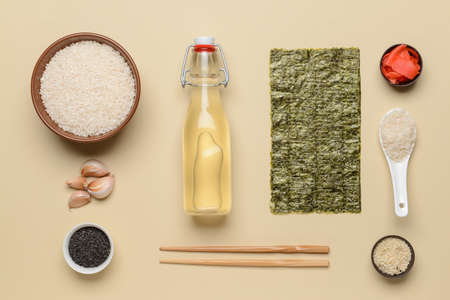 Composition with ingredients for preparing sushi rolls and rice vinegar on color backgroundの写真素材