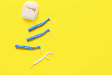 Toothbrushes for dental braces and floss on color backgroundの写真素材