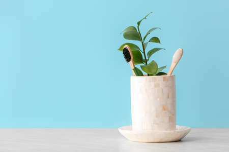 Holder with wooden toothbrushes on tableの写真素材