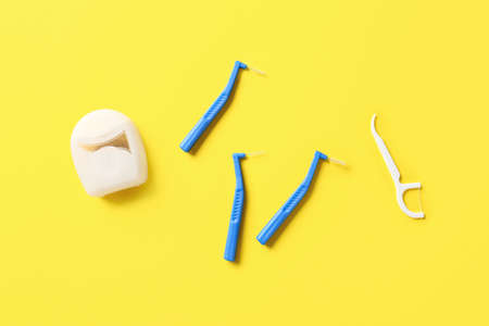 Toothbrushes for dental braces and floss on color backgroundの写真素材