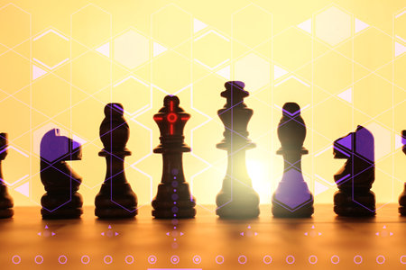 Chess pieces on checkerboard against color backgroundの写真素材