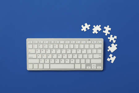 Computer keyboard and puzzles on color backgroundの写真素材