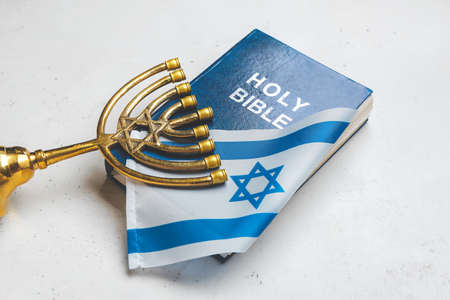 Flag of Israel, Holy Bible and menorah on light backgroundの写真素材