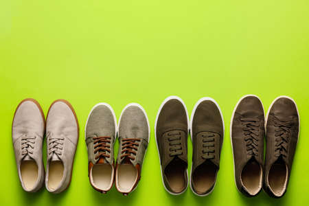 Different casual male shoes on color backgroundの写真素材