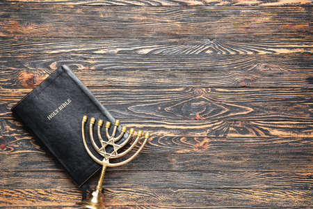 Holy Bible and menorah on wooden backgroundの写真素材