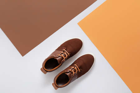 Casual male shoes on color background
