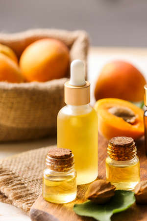 Bottles of apricot essential oil on tableの写真素材