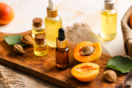 Bottles of apricot essential oil on tableの写真素材