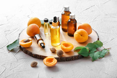 Bottles of apricot essential oil on light backgroundの写真素材