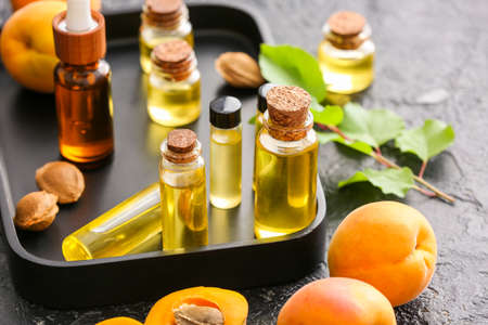 Bottles of apricot essential oil on dark backgroundの写真素材