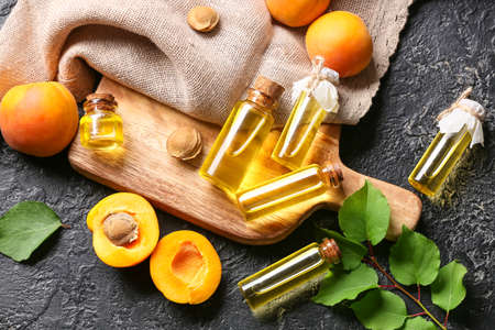 Bottles of apricot essential oil on dark backgroundの写真素材