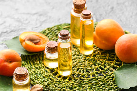 Bottles of apricot essential oil on dark backgroundの写真素材