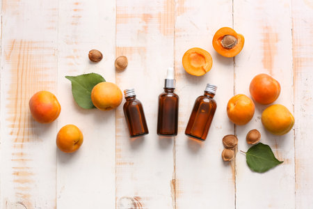 Bottles of apricot essential oil on tableの写真素材