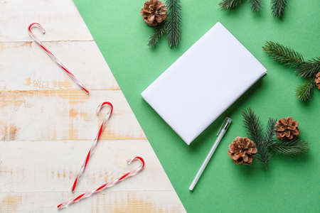 Blank book and Christmas decor on color backgroundの写真素材