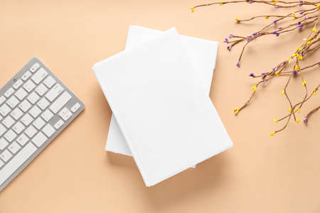 Composition with blank books and computer keyboard on color background