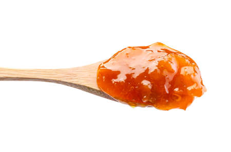 Spoon of tasty peach jam on white backgroundの写真素材