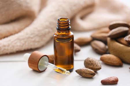 Bottle with almond essential oil on tableの写真素材