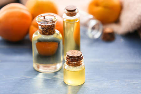 Bottles of apricot essential oil on tableの写真素材