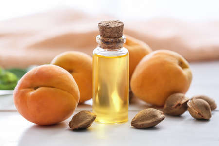 Bottle of apricot essential oil on tableの写真素材