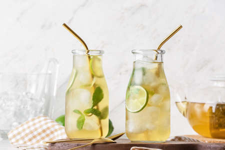 Bottles of tasty cold ice tea on table