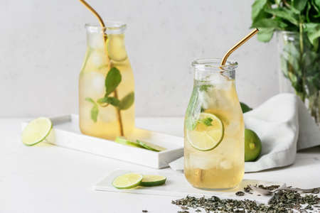 Bottles of tasty cold ice tea on table