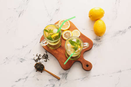 Cups of tasty cold ice tea on tableの写真素材