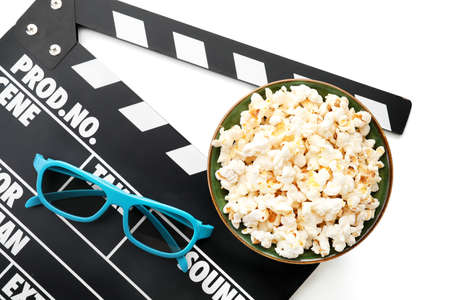 Bowl of popcorn, 3D glasses and clapperboard isolated on white backgroundの写真素材