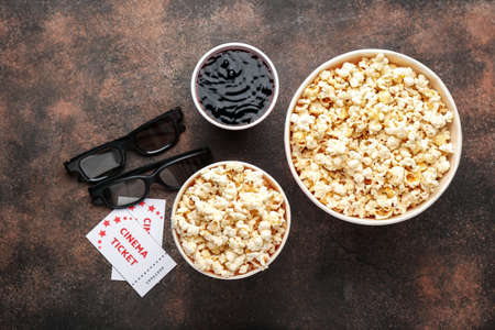 Popcorn, 3D glasses, cola and cinema tickets on grunge backgroundの写真素材