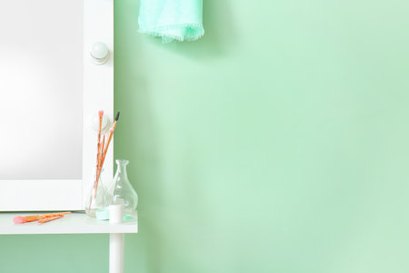Dressing table near stylish mint wall in roomの写真素材