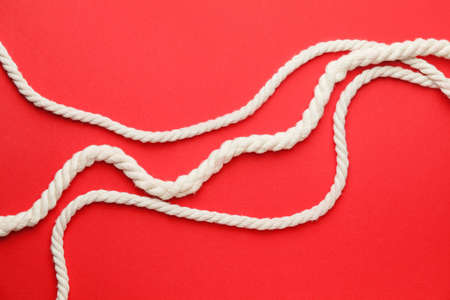 Long ropes on color background