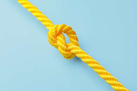 Rope with knot on color backgroundの写真素材