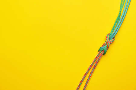 Ropes with knot on color background