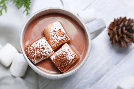 Cup of hot cacao drink with marshmallows on tableの写真素材