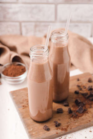 Bottles of aromatic chocolate milk on tableの写真素材