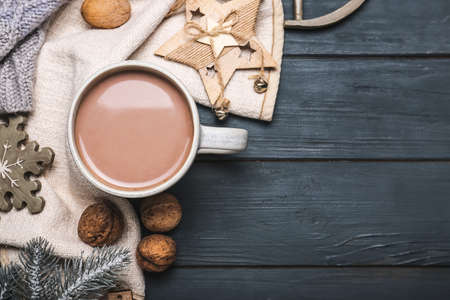 Cup of hot cacao drink with Christmas decorations on dark wooden backgroundの写真素材