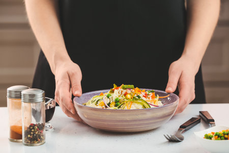 Woman with tasty fried rice in bowl, closeupの写真素材