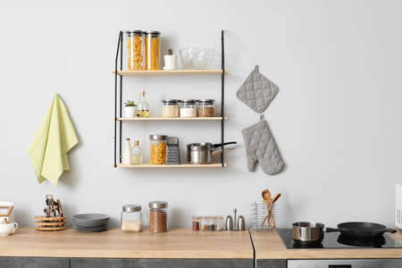 Interior of modern kitchen with shelves