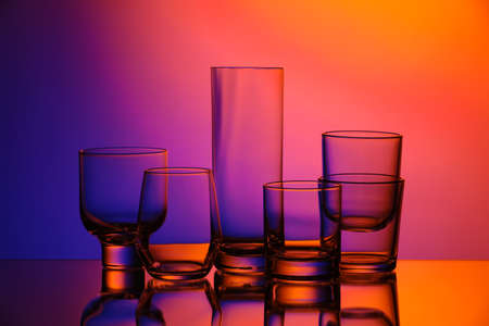 Empty glasses on color backgroundの写真素材