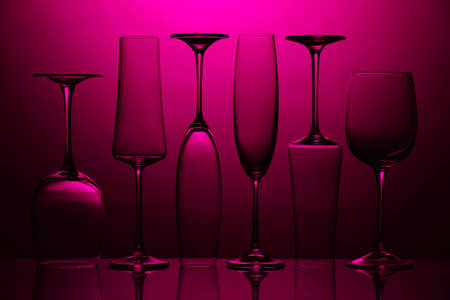 Empty glasses on color backgroundの写真素材