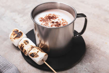 Cup of tasty cocoa drink and marshmallows on tableの写真素材