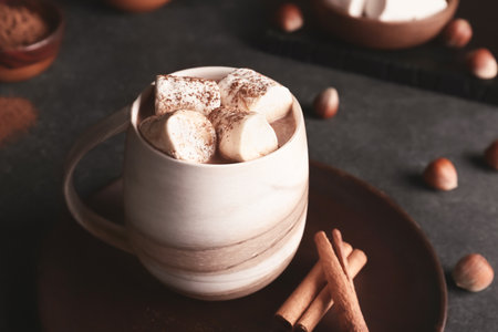 Cup of tasty cocoa drink with marshmallows on tableの写真素材